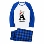 A two-piece pajama set on a white background, featuring a long-sleeve raglan top in royal blue and white with a personalized Christmas graphic of the letter 'A' wearing a Santa hat, and matching blue and black plaid pajama pants.