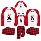 A matching family Christmas pajama set for four, including two long-sleeve raglan shirts, two pants, and a one-piece, all in white and red with a personalized 'A' and 'Amelia' graphic featuring a Santa-clad reindeer. Two additional pairs of red and black plaid pants are shown.