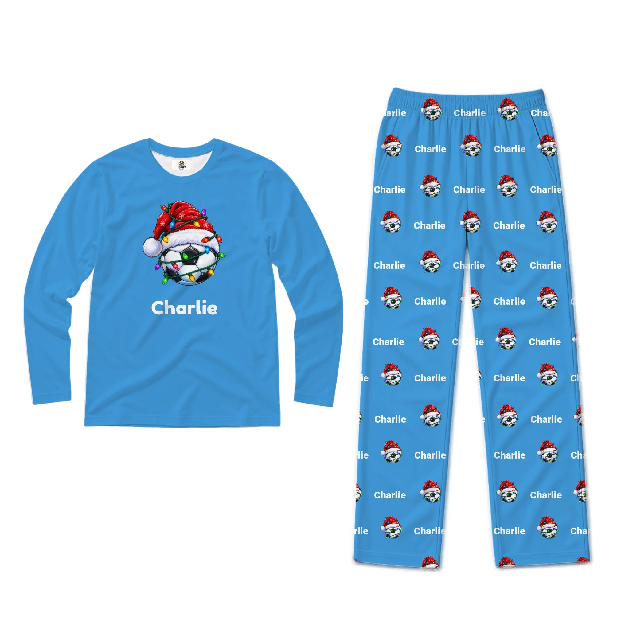 A two-piece kids' pajama set on a white background, featuring a long-sleeve blue shirt with a Christmas soccer ball graphic and the name 'Charlie', paired with matching blue pants covered in a repeating pattern of the same graphic.