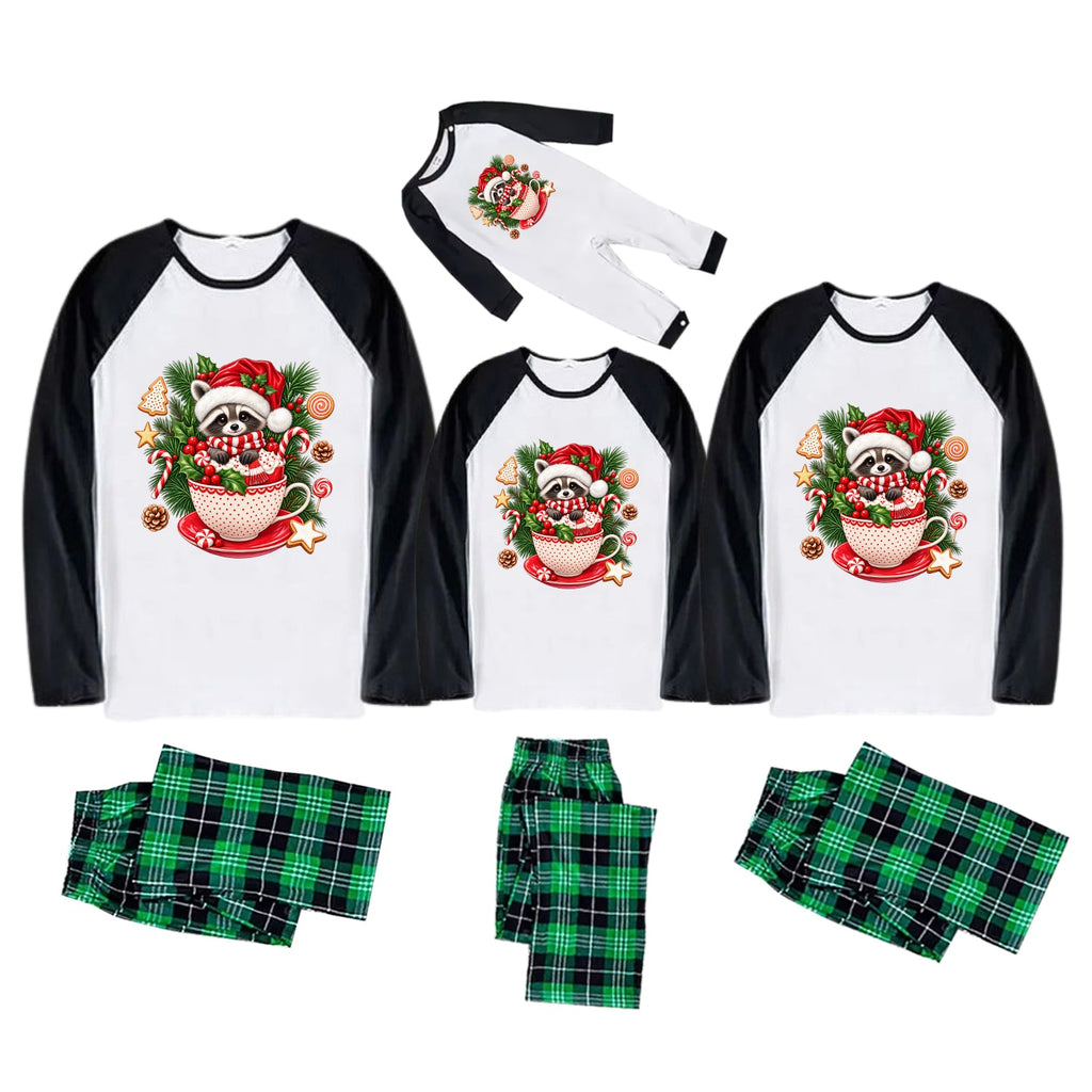 Three matching Christmas family pajama sets shown on a white background, each with a white raglan long-sleeve top featuring a festive panda in a teacup graphic and black sleeves, paired with green plaid pajama pants.