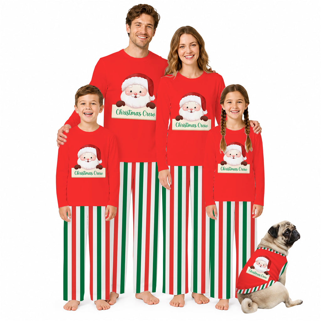 A family of four and a dog wearing matching red Christmas pajamas with Santa graphics and green and white vertical stripes, posed against a plain white background.