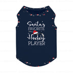 A Navy Blue sleeveless pet shirt with a festive holiday graphic. The design features the text 'Santa's FAVORITE Hockey PLAYER' in White script and block lettering, accompanied by a small illustration of a hockey stick and helmet with a Santa hat.