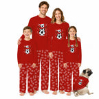 A family of four and a pug wearing matching red Christmas-themed pajamas with a soccer-themed panda graphic on the chest and a red-and-white patterned design on the pants, posed against a solid white background.