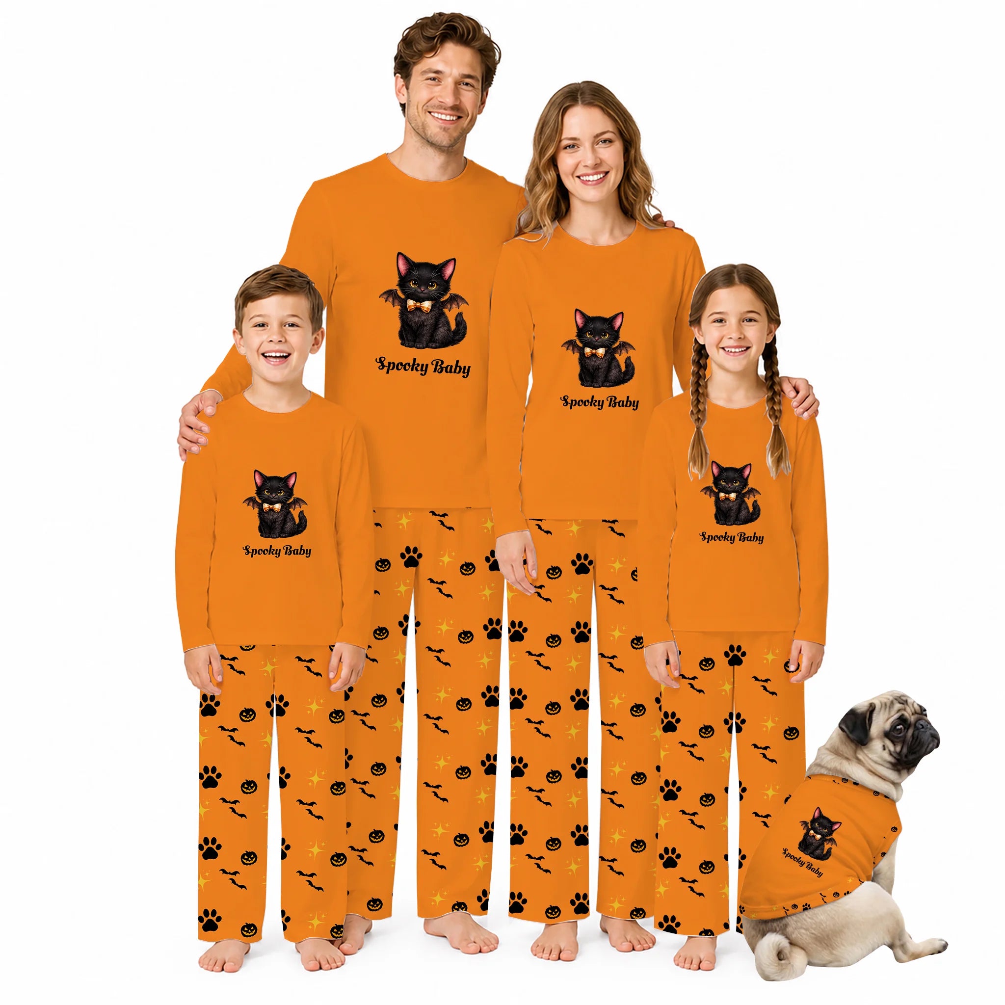 A family of four and a dog wearing matching orange Halloween pajamas with a black cat graphic and 'Spooky Baby' text, posed against a plain white background.