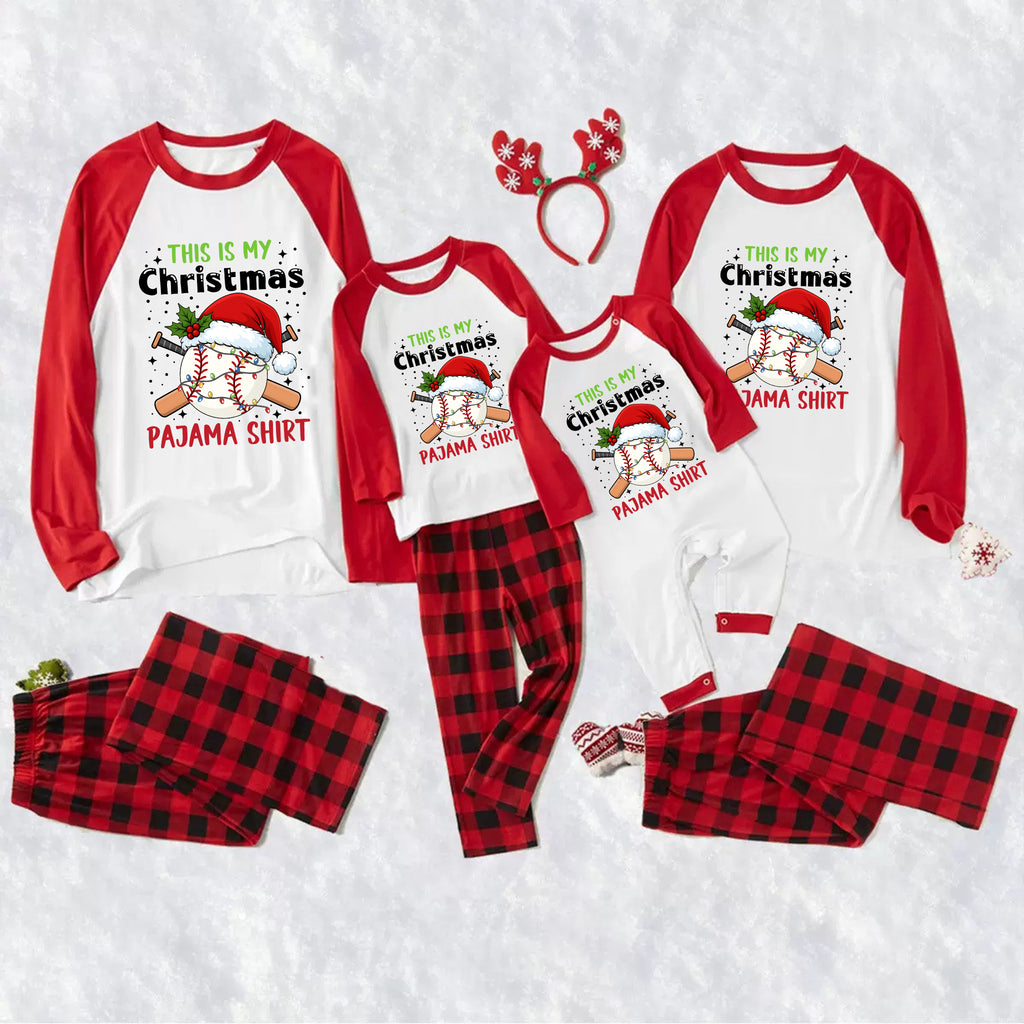 A family Christmas pajama set laid out on a white textured background, featuring matching long-sleeve raglan shirts and plaid pants in red and black buffalo plaid. The shirts are white with red sleeves and a graphic of a baseball wearing a Santa hat with the text 'THIS IS MY Christmas PAMA SHIRT'.