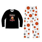 A two-piece kids' pajama set displayed on a plain white background. The set includes a black long-sleeve shirt with a colorful Christmas turkey graphic and text reading 'This is my CHRISTMAS PJMAMA SHIRT', and white pants covered in an all-over print of orange basketballs and black snowflakes.