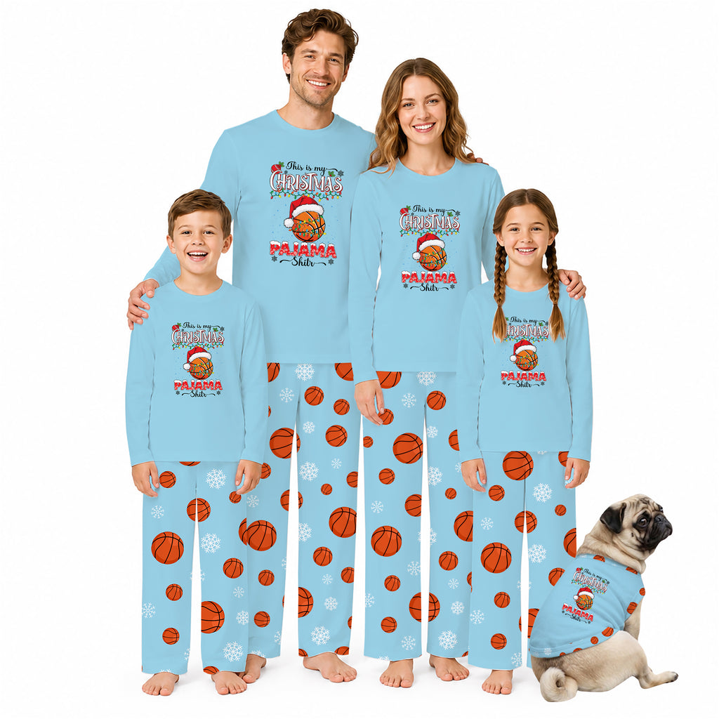 A family of four wearing matching light blue Christmas-themed pajamas with basketball and snowflake prints, standing together on a white background, with a small pug dog wearing a matching pajama set at the bottom right.