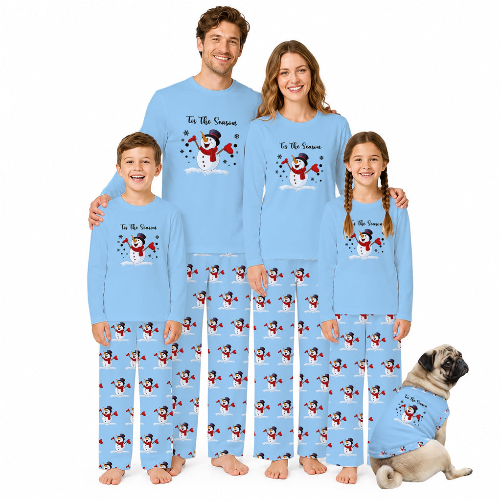 A family of four wearing matching light Blue pajamas with a snowman graphic and text reading 'To The Snowman,' plus a matching dog in a small pajama shirt, photographed against a plain White background.