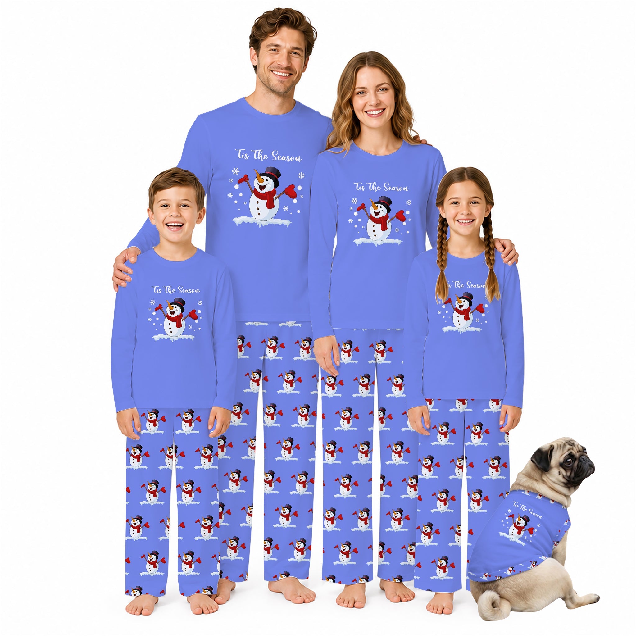 A family of four wearing matching Blue long-sleeve pajamas with a snowman graphic and text, standing together on a White background, with a small dog sitting beside them in matching pajamas.