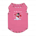 A Pink pet tank top featuring a central snowman graphic with the text 'Tis The Season' and a penguin pattern along the neckline and bottom hem, shown on a White background with faint watermarks.